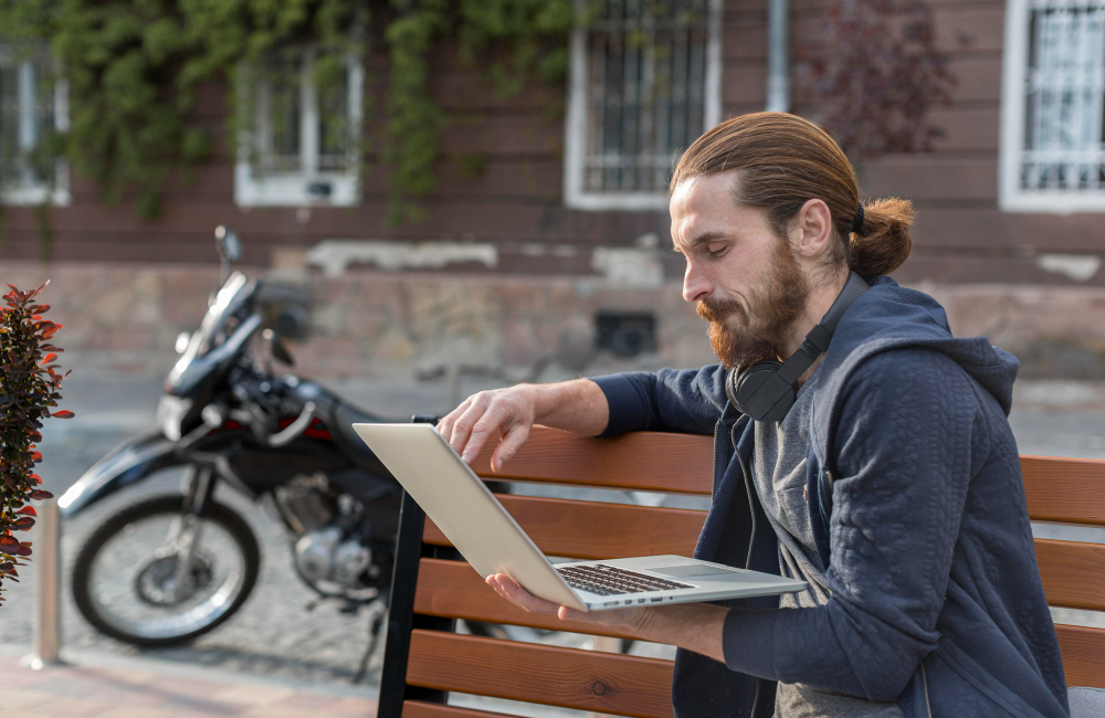 side-view-man-with-laptop-city